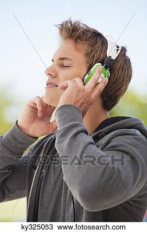 Man listening to music with headphones View Large Photo Image Stock Image - Man listening to music with headphones. Fotosearch