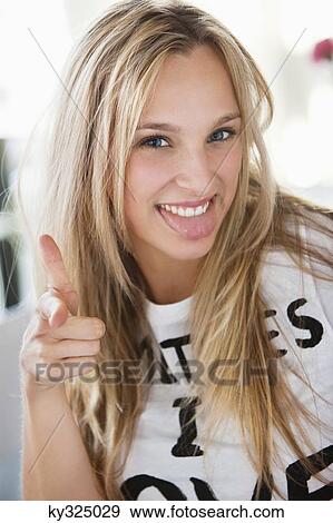 Portrait of a beautiful woman showing gun sign at a cafe View Large Photo Image Stock Photo - Portrait of a beautiful woman showing gun sign at a cafe. Fotosearch