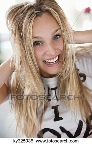 Stock Photograph - Portrait of a beautiful woman smiling in a cafe. Fotosearch