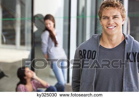 Portrait of a man smiling in a campus View Large Photo Image Stock Image - Portrait of a man smiling in a campus. Fotosearch