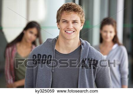 Portrait of a man smiling in a campus View Large Photo Image Stock Photo - Portrait of a man smiling in a campus. Fotosearch