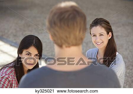 Three friends having discussion View Large Photo Image Stock Image - Three friends having discussion. Fotosearch