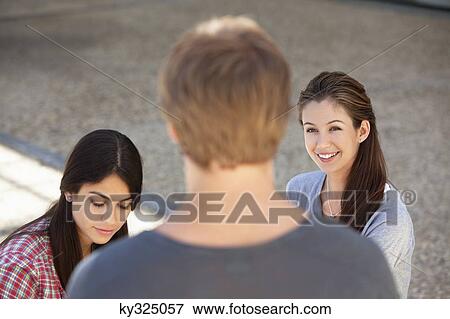 Three friends having discussion View Large Photo Image Stock Photo - Three friends having discussion. Fotosearch