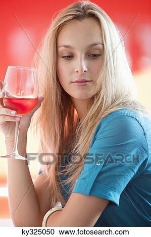 Young woman having red wine and thinking in a bar View Large Photo Image Stock Image - Young woman having red wine and thinking in a bar. Fotosearch