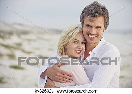Close-up of a couple embracing each other and smiling View Large Photo Image Stock Photo - Close-up of a couple embracing each other and smiling. Fotosearch