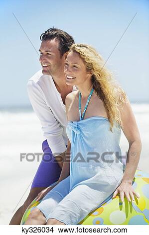 Couple smiling on the beach View Large Photo Image Picture - Couple smiling on the beach. Fotosearch