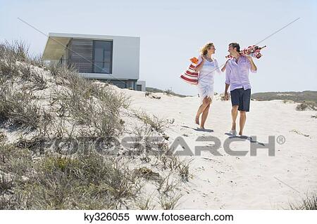 Stock Photography - Couple walking on the beach. Fotosearch