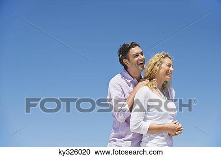 Side profile of a couple smiling View Large Photo Image Stock Image - Side profile of a couple smiling. Fotosearch