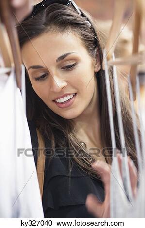 Stock Image - Beautiful young woman shopping. Fotosearch