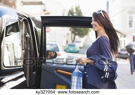 Side profile of a beautiful woman getting into the car View Large Photo Image Picture - Side profile of a beautiful woman getting into the car. Fotosearch