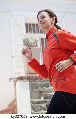 Side profile of a beautiful young woman jogging View Large Photo Image Stock Photo - Side profile of a beautiful young woman jogging. Fotosearch
