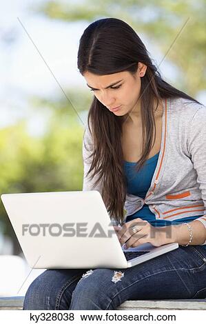 Close-up of a woman using a laptop View Large Photo Image Stock Photo - Close-up of a woman using a laptop. Fotosearch