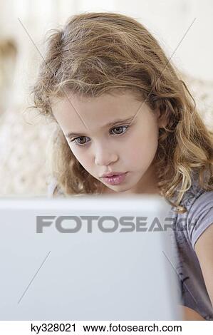 Cute little girl using a laptop in the bed View Large Photo Image Stock Image - Cute little girl using a laptop in the bed. Fotosearch