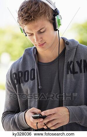 Man listening to music with headphones View Large Photo Image Stock Photograph - Man listening to music with headphones. Fotosearch