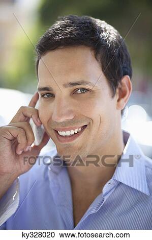 Mid adult man talking on a mobile phone View Large Photo Image Stock Image - Mid adult man talking on a mobile phone. Fotosearch
