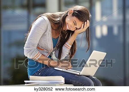Portrait of a smiling woman using a laptop View Large Photo Image Stock Image - Portrait of a smiling woman using a laptop. Fotosearch