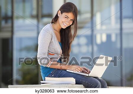 Portrait of a smiling woman using a laptop View Large Photo Image Stock Image - Portrait of a smiling woman using a laptop. Fotosearch