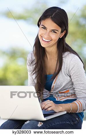 Stock Image - Portrait of a woman using a laptop. Fotosearch