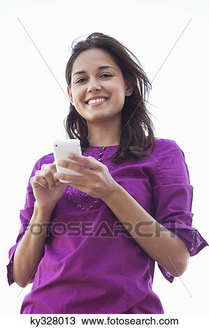 Young woman using a mobile phone View Large Photo Image Stock Image - Young woman using a mobile phone. Fotosearch