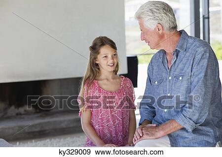 Man talking to his granddaughter View Large Photo Image Stock Photo - Man talking to his granddaughter. Fotosearch