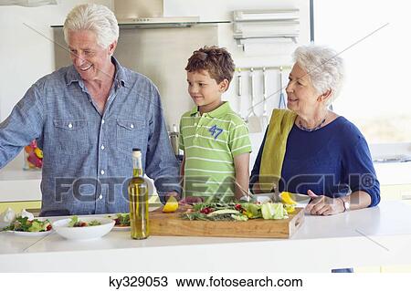 Senior couple preparing food with their grandson View Large Photo Image Stock Image - Senior couple preparing food with their grandson. Fotosearch