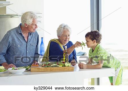 Senior couple with their grandson at a kitchen counter View Large Photo Image Picture - Senior couple with their grandson at a kitchen counter. Fotosearch