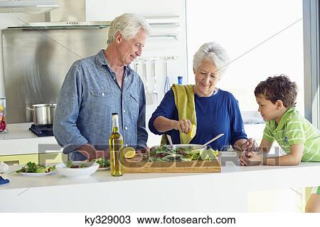 Senior couple with their grandson at a kitchen counter View Large Photo Image Stock Image - Senior couple with their grandson at a kitchen counter. Fotosearch