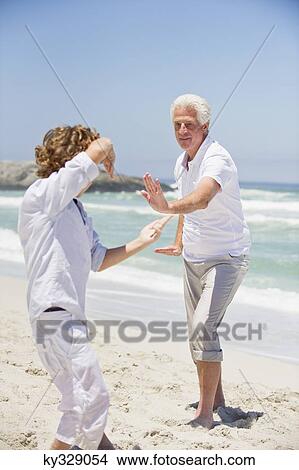 Senior man teaching martial arts to his grandson View Large Photo Image Picture - Senior man teaching martial arts to his grandson. Fotosearch