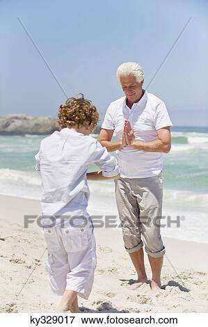Stock Photo - Senior man teaching martial arts to his grandson. Fotosearch
