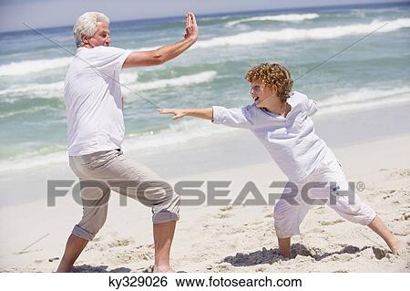 Senior man teaching martial arts to his grandson View Large Photo Image Stock Photograph - Senior man teaching martial arts to his grandson. Fotosearch