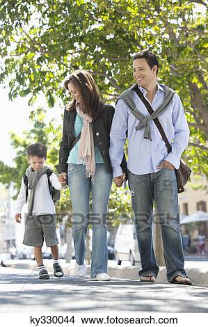 Family walking together on the road View Large Photo Image Picture - Family walking together on the road. Fotosearch