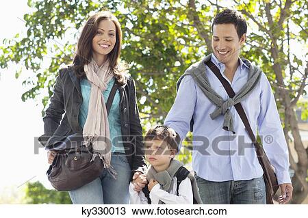 Family walking together on the road View Large Photo Image Stock Image - Family walking together on the road. Fotosearch