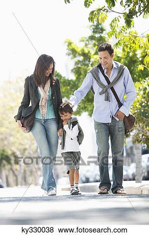 Stock Photo - Family walking together on the road. Fotosearch