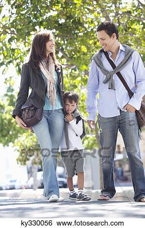 Stock Photograph - Family walking together on the road. Fotosearch