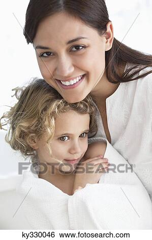 Portrait of a woman with her daughter wrapped in a towel View Large Photo Image Stock Photograph - Portrait of a woman with her daughter wrapped in a towel. Fotosearch