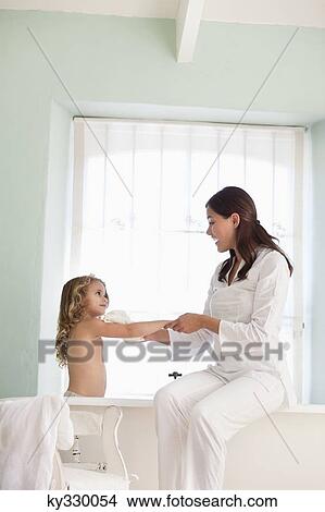 Woman giving a bath to her daughter View Large Photo Image Picture - Woman giving a bath to her daughter. Fotosearch