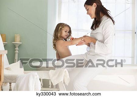 Woman giving a bath to her daughter View Large Photo Image Stock Image - Woman giving a bath to her daughter. Fotosearch