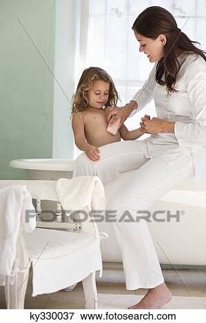 Woman giving a bath to her daughter View Large Photo Image Stock Photo - Woman giving a bath to her daughter. Fotosearch