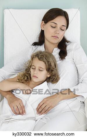 Young woman sleeping with little girl wrapped in towel View Large Photo Image Stock Image - Young woman sleeping with little girl wrapped in towel. Fotosearch