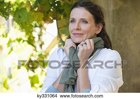 Beautiful mature woman day dreaming View Large Photo Image Picture - Beautiful mature woman day dreaming. Fotosearch