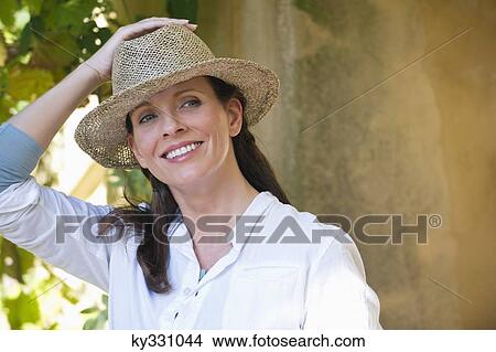 Beautiful mature woman wearing hat and smiling View Large Photo Image Picture - Beautiful mature woman wearing hat and smiling. Fotosearch