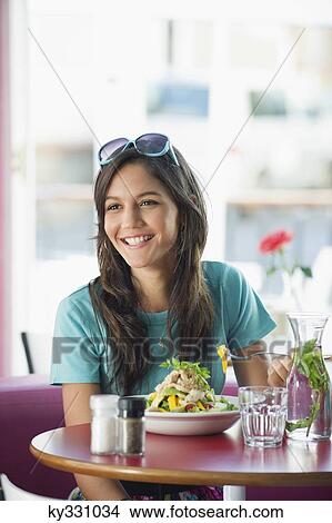 Beautiful woman eating food in a restaurant View Large Photo Image Picture - Beautiful woman eating food in a restaurant. Fotosearch