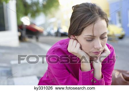 Depressed young woman sitting at the roadside View Large Photo Image Stock Photograph - Depressed young woman sitting at the roadside. Fotosearch