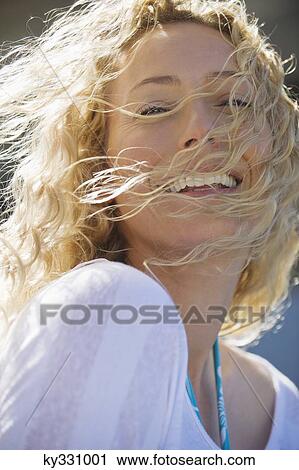Stock Image - Portrait of a beautiful woman smiling. Fotosearch