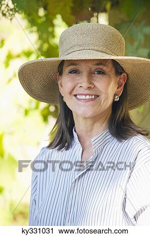 Portrait of a senior woman wearing hat and smiling View Large Photo Image Stock Image - Portrait of a senior woman wearing hat and smiling. Fotosearch