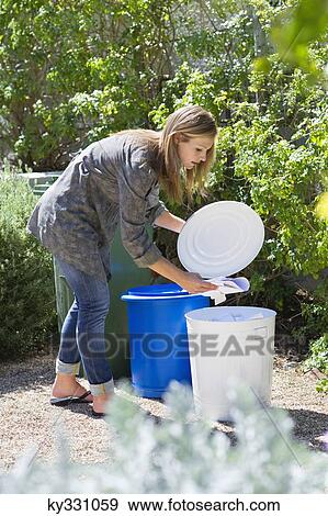 Woman throwing papers in garbage bin View Large Photo Image Stock Photo - Woman throwing papers in garbage bin. Fotosearch