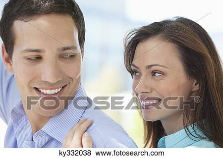 Romantic couple smiling at each other View Large Photo Image Stock Photo - Romantic couple smiling at each other. Fotosearch
