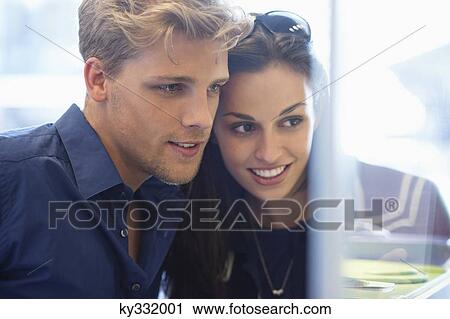 Young couple doing window shopping View Large Photo Image Stock Image - Young couple doing window shopping. Fotosearch