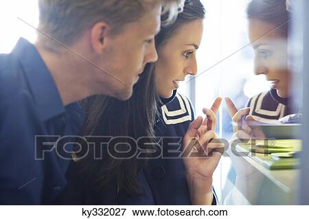 Young couple doing window shopping View Large Photo Image Stock Photo - Young couple doing window shopping. Fotosearch