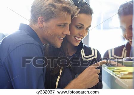 Young couple doing window shopping View Large Photo Image Stock Photo - Young couple doing window shopping. Fotosearch